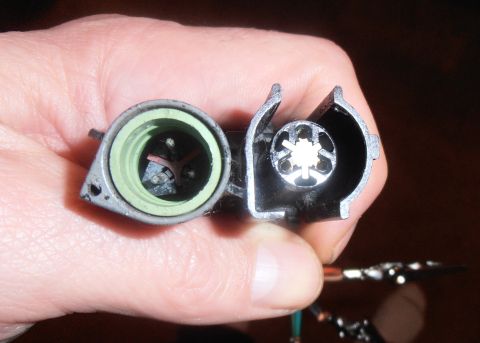 1990 Ford Bronco - Close-up of a throttle position sensor connector, showing internal contacts and a green seal.