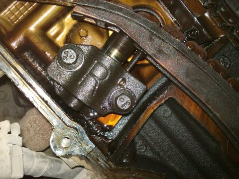 1998 Ford Crown Victoria - This is a close-up view of an engine's internal timing chain tensioner mechanism.