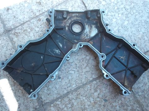 1998 Ford Crown Victoria - Engine timing cover, likely from a Ford vehicle, shown disassembled.