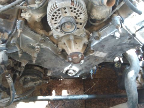 1998 Ford Crown Victoria - Engine timing cover and water pump assembly, likely from a Ford modular V8 engine.