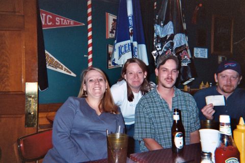 1988 Ford Bronco - People gather at a bar, with sports pennants and umbrellas visible on the wall.