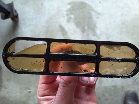 1993 Ford F-150 - A dirty oil filter shows accumulated sludge in its compartments, indicating a need for replacement.