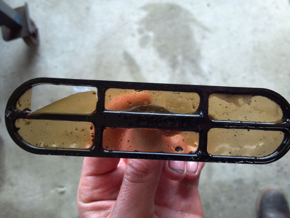 Dirty oil filter with brown sludge in compartments