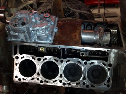 1993 Ford F-150 - Disassembled engine components, including the cylinder block and oil filter housing, are laid out for inspection or repair.