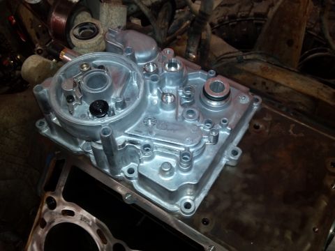 1993 Ford F-150 - A close-up view of a disassembled engine part, showing intricate metalwork and assembly points.