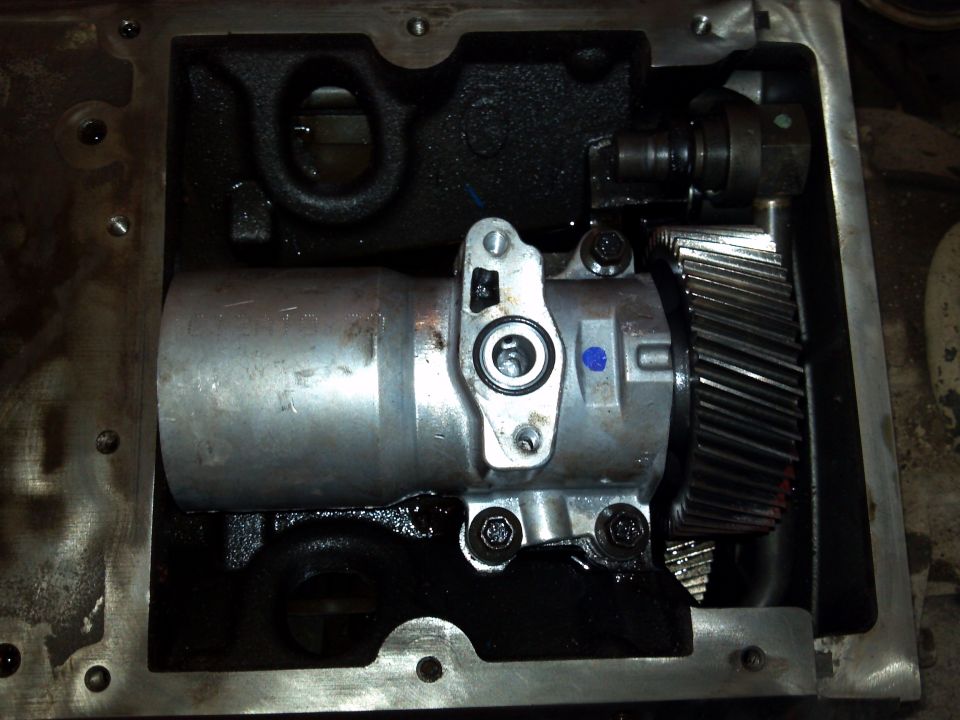 Close-up of internal truck transmission components, including gears and a pump