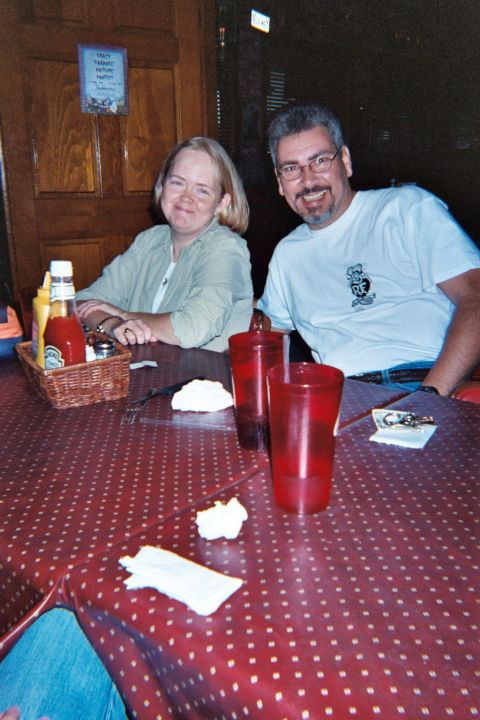 1988 Ford Bronco - A couple smiles for the camera while seated at a table with ketchup, mustard, and drinks.