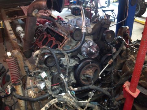 1993 Ford F-150 - The engine is partially disassembled and appears to be undergoing maintenance or repair in a workshop setting.
