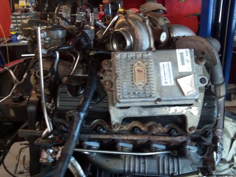 1993 Ford F-150 - This is a close-up view of a diesel engine, its turbocharger and electronic control unit.