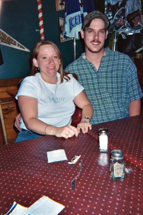 1988 Ford Bronco - A couple poses for a photo at a table, with salt and pepper shakers nearby.