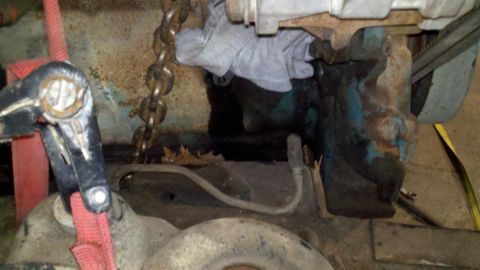 1993 Ford F-350 - Close-up view of engine components being worked on, with visible rust and a chain hoist.