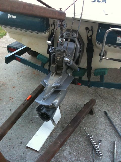 1978 Chevrolet Camaro - The rear of a boat is shown on a trailer, with its motor assembly detached and resting on supports.