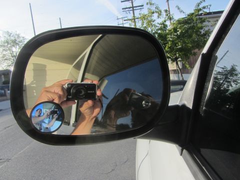 1968 Ford Mustang - A person captures a selfie using a side-view mirror, showing a reflection of their camera and a smaller convex mirror.