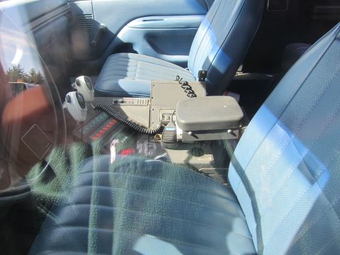 1991 Ford Crown Victoria LTD - The interior of a vehicle is equipped with police radio and communication devices between the seats.