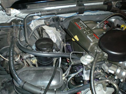 1996 Ford Bronco - Close-up view of a vehicle's engine bay, showing various components and wiring.