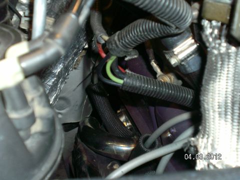 1996 Ford Bronco - A close-up view of the engine bay shows various wires, hoses, and part of the exhaust system.