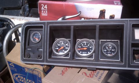 1978 Ford Bronco - A set of aftermarket dashboard gauges, including a tachometer, oil pressure, and fuel level, are displayed.