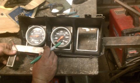 1978 Ford Bronco - A close-up view of a vehicle's dashboard gauge cluster, showing two active gauges and two empty openings.