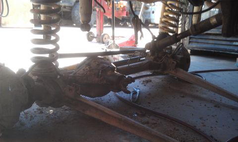 1978 Ford Bronco - Close-up view of the undercarriage, focusing on the suspension and axle assembly of a vehicle.