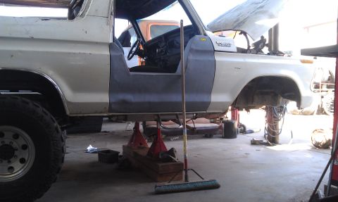 1978 Ford Bronco - This Ford Bronco is being worked on in a garage, with its body lifted and doors off.