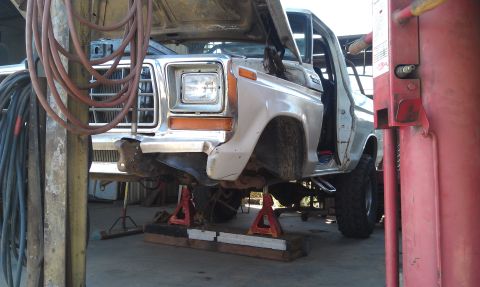1978 Ford Bronco - This 1979 Ford truck is undergoing repairs, supported by jack stands with its front end and grille clearly visible.