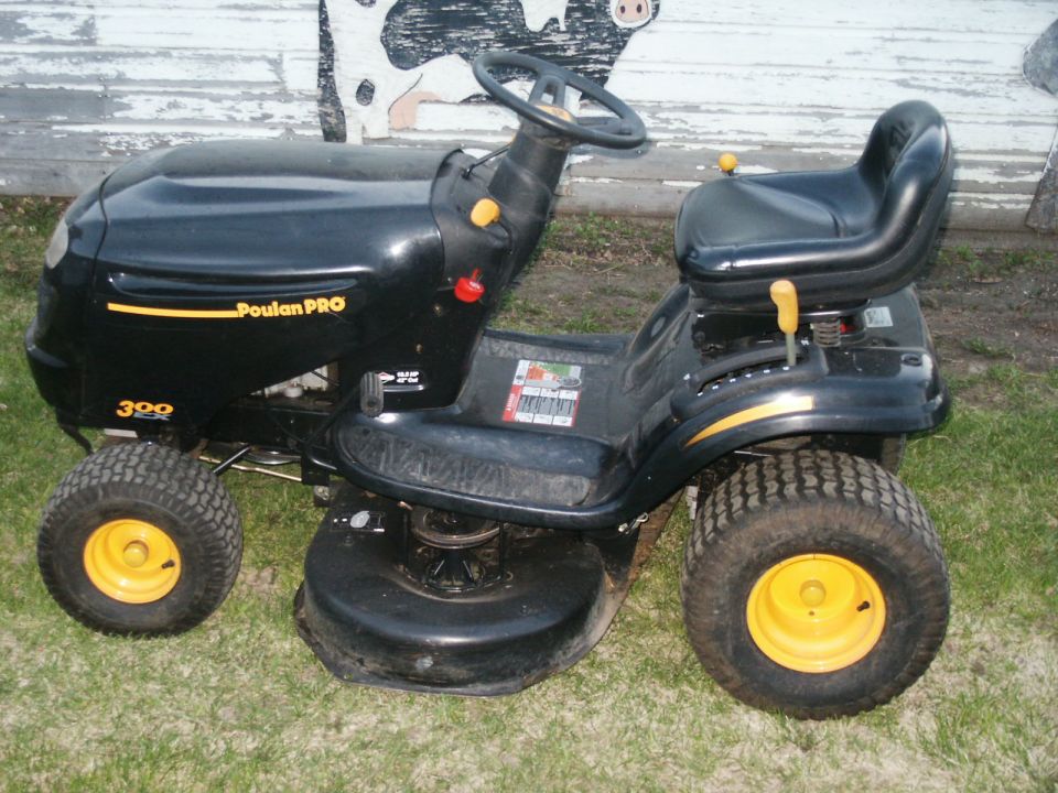 Black Poulan PRO riding mower with yellow wheels and deck
