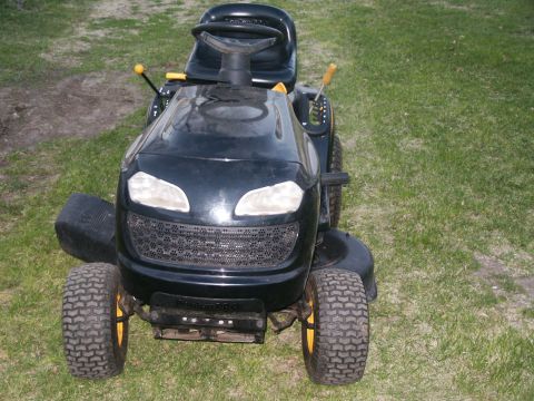 1966 Ford Bronco - This riding lawn mower is black with yellow accents on the wheels and levers.
