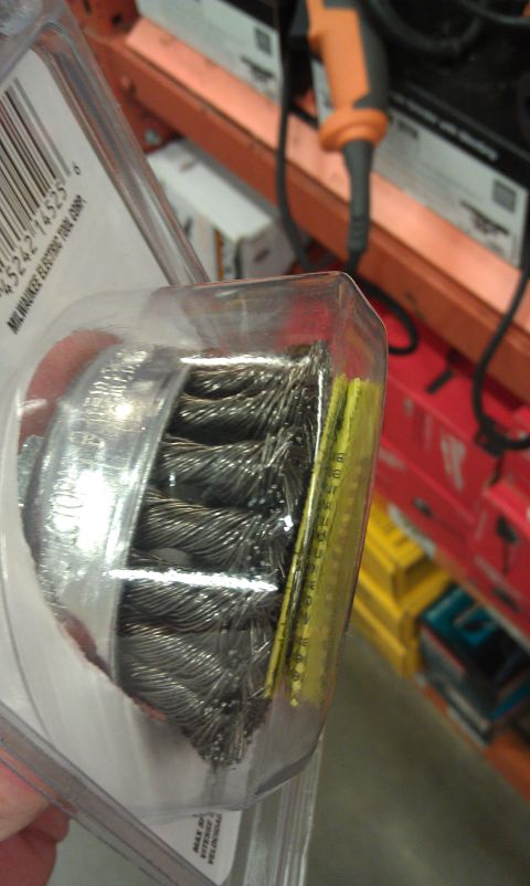 1978 Ford Bronco - A wire wheel brush is packaged with a barcode and text, with an orange tool visible in the background.