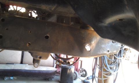 1978 Ford Bronco - Underside view of vehicle frame and suspension components, showing rust and wear.