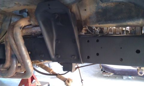 1978 Ford Bronco - Close-up of the vehicle's frame and exhaust system, showing structural components and piping.
