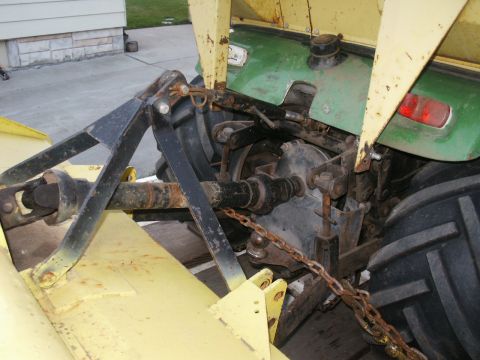 1966 Ford Bronco - Rear view of a tractor, showing its hitch mechanism and green body panels.