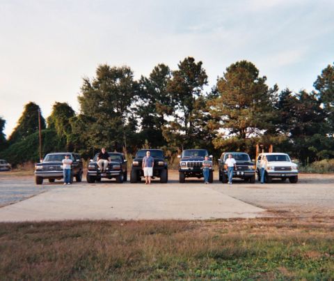 1988 Ford Bronco - A group of friends and their vehicles are gathered together outdoors.