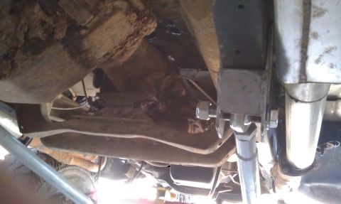 1978 Ford Bronco - Close-up of vehicle undercarriage, focusing on suspension and exhaust system components.