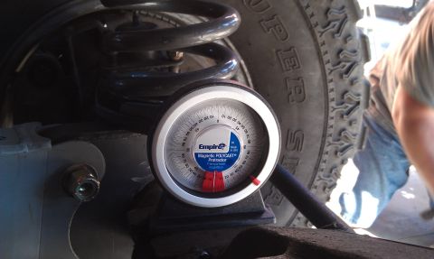 1978 Ford Bronco - A magnetic protractor is used to measure alignment on a vehicle's suspension system.