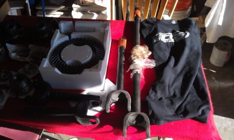 1978 Ford Bronco - Various automotive parts, including a differential ring gear and axle shafts, are displayed on a red cloth.