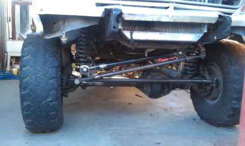 1978 Ford Bronco - Close-up view of the front axle and suspension system of a modified off-road vehicle.