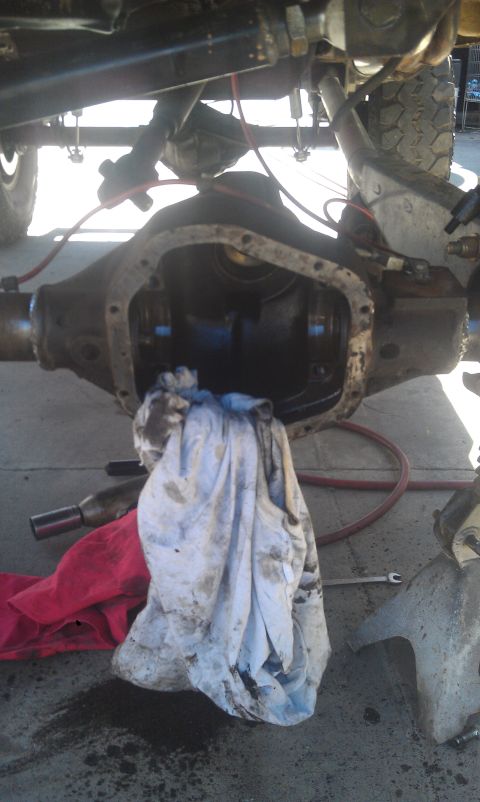 1978 Ford Bronco - The differential cover is removed, revealing the internal components of the axle assembly.