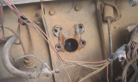 1978 Ford Bronco - Rusty brake booster mounting bracket with wiring and hoses visible.
