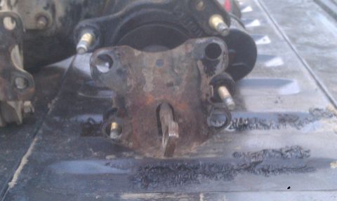 1978 Ford Bronco - A close-up view of a corroded mechanical component, possibly a brake or clutch part, with visible mounting studs.