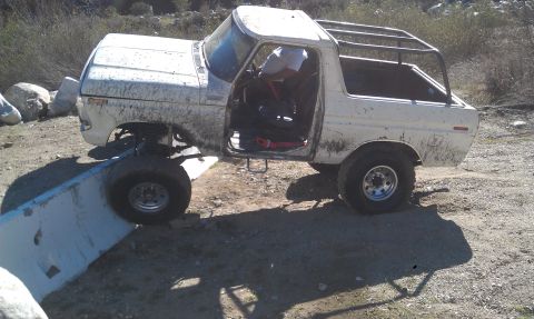 1978 Ford Bronco - This 1978 Ford Bronco is shown navigating an off-road obstacle with its front tire on a concrete barrier.