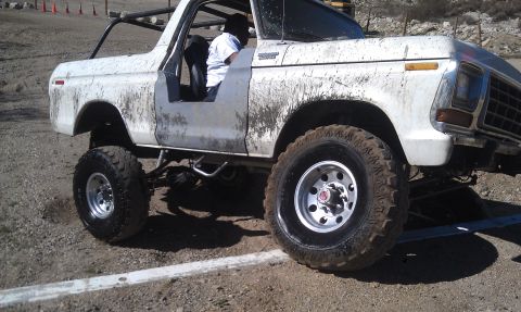 1978 Ford Bronco - A muddy 1978 Ford Bronco is shown with its doors removed, modified for off-road use.