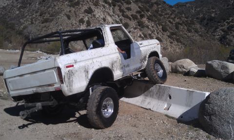 1978 Ford Bronco - This 1978 Ford Bronco is shown navigating an off-road obstacle, demonstrating its suspension capabilities.