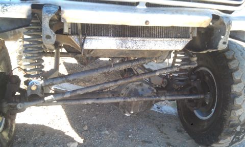 1978 Ford Bronco - Close-up view of the front suspension and radiator of an off-road vehicle, showing its heavy-duty components.