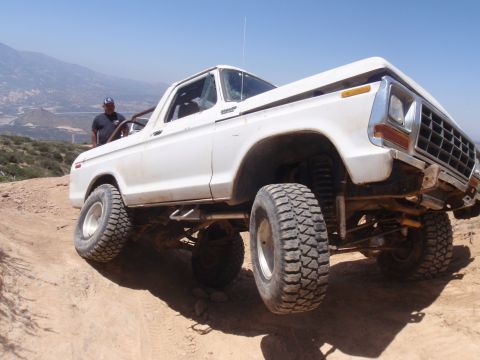 1978 Ford Bronco - This lifted 1978 Ford Bronco navigates a off-road course under a clear blue sky.