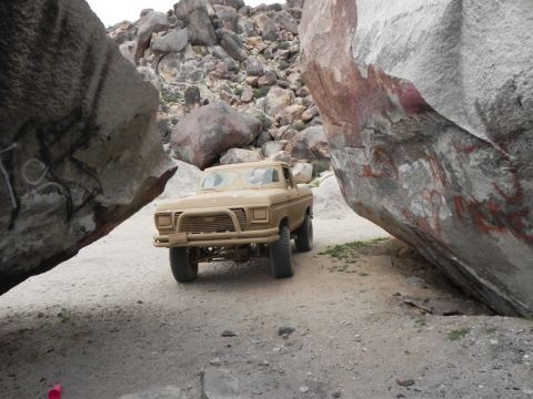1978 Ford Bronco - Pickup truck navigates a rocky off-road path in a desert landscape.