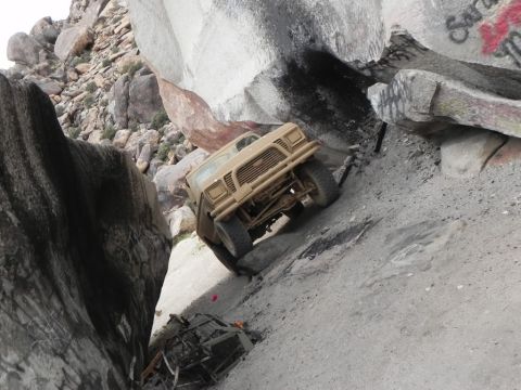 1978 Ford Bronco - An off-road vehicle navigates a challenging rocky path, with another vehicle visible below.