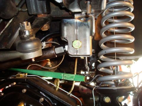 1995 Ford Bronco - Undercarriage view of suspension and steering parts, including a ball joint and coil spring.