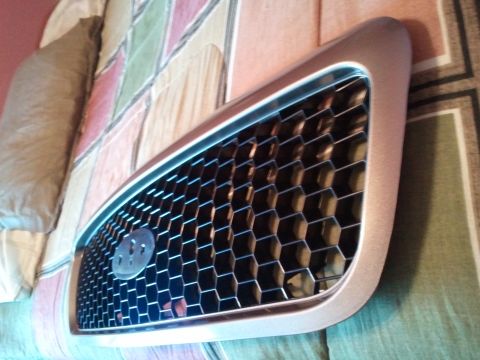 2007 Ford Crown Victoria - A close-up view of a car's front grille, showing its hexagonal mesh design.