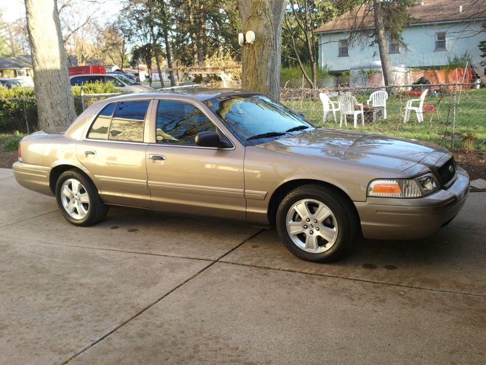 Tan 2007 Ford Crown Victoria parked on a driveway