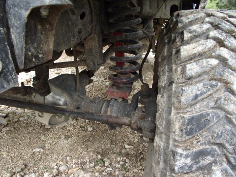 1989 Ford Bronco - This image shows the heavy-duty suspension and large tire of an off-road vehicle.